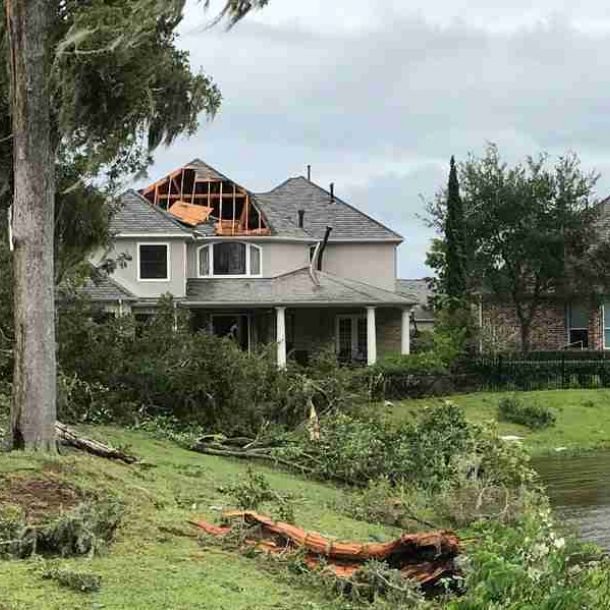Emergency roof repair after storm damage in residential home.